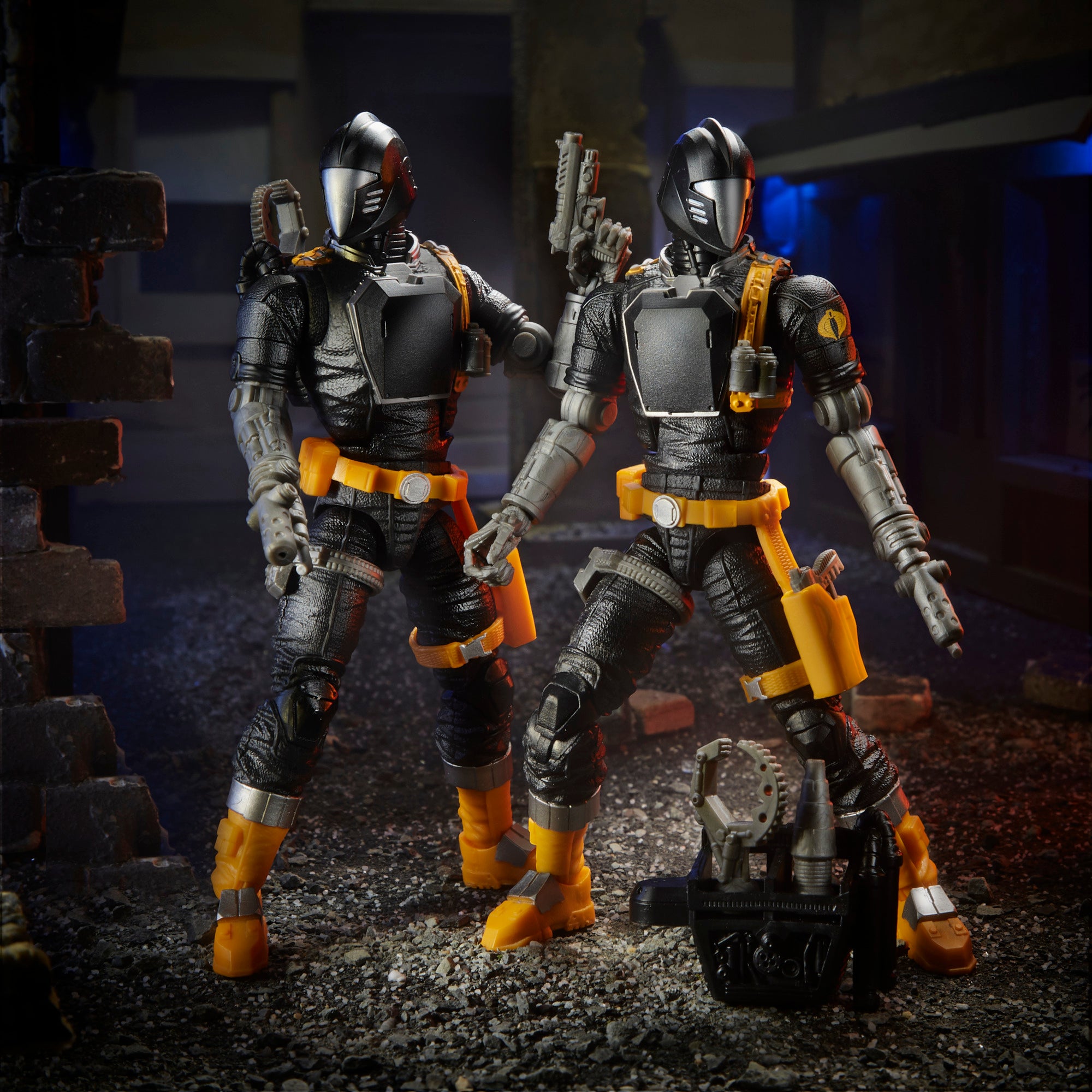 G.I. Joe Classified Series two B.A.T. figures standing in dark urban diorama with equipment case on ground