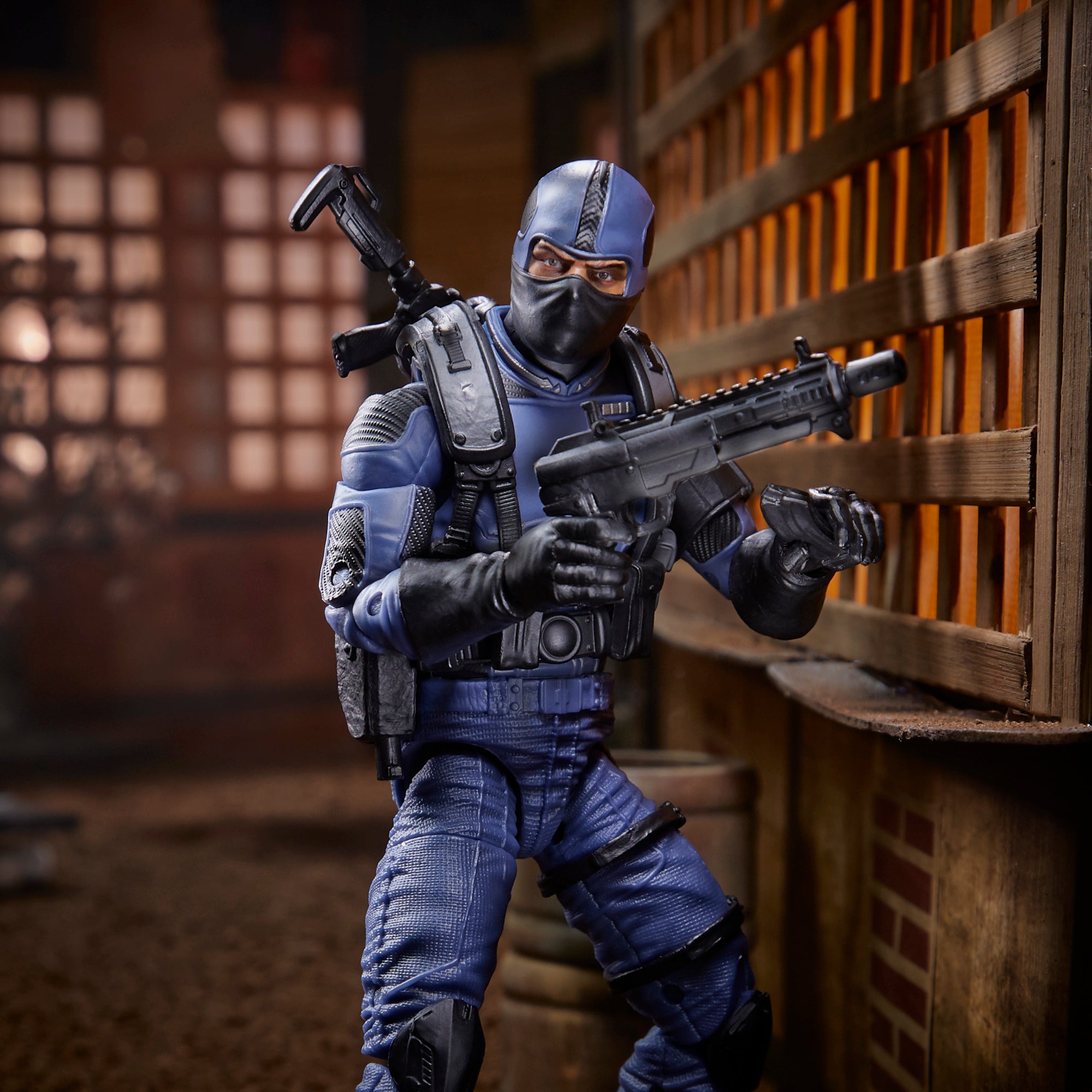 G.I. Joe Classified Series Cobra Officer leaning against wooden wall in dojo diorama holding assault rifle with hooded head