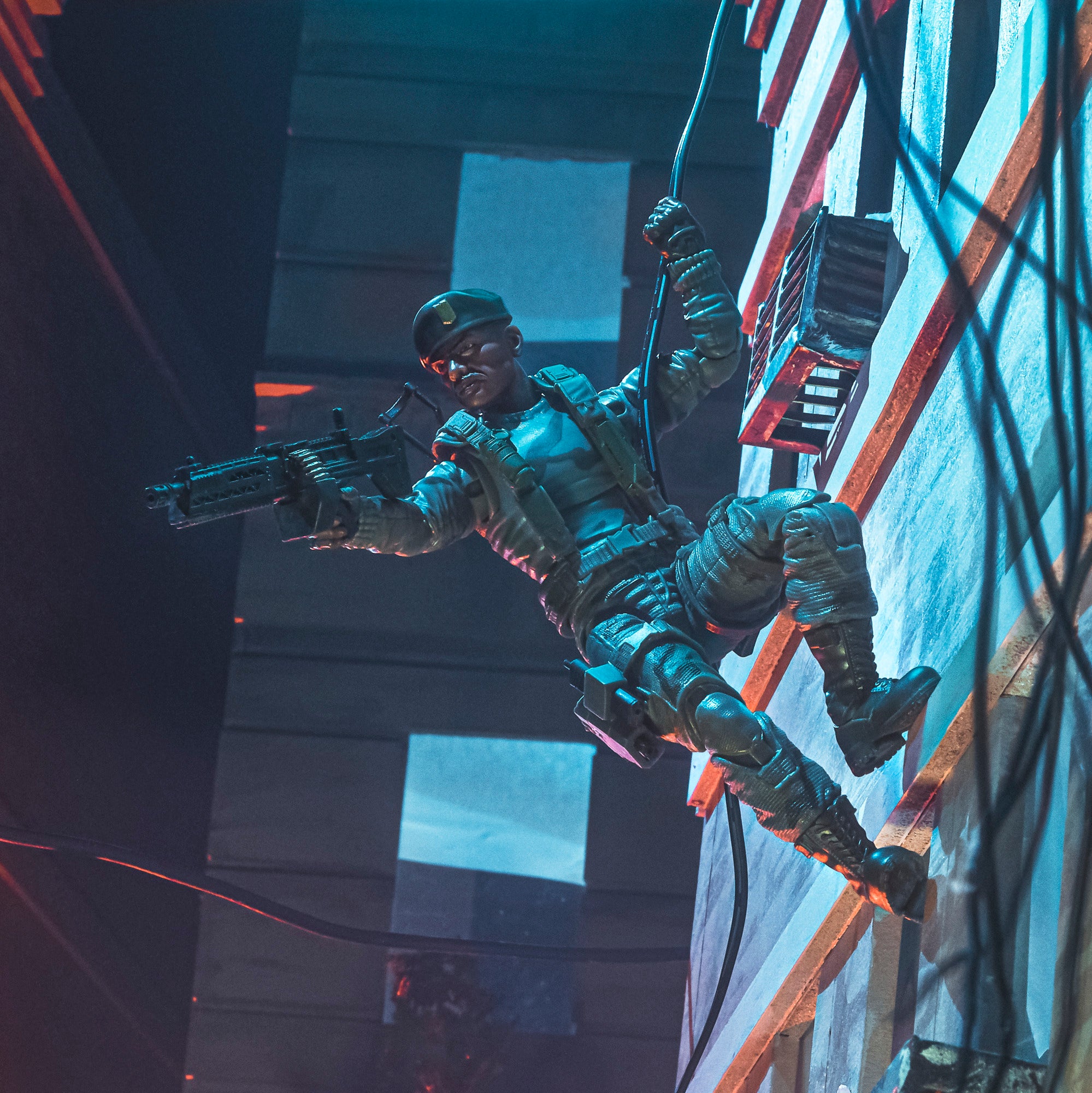 G.I. Joe Classified Series Stalker Wilkinson rappelling down building wall in urban night diorama holding machine gun one-handed