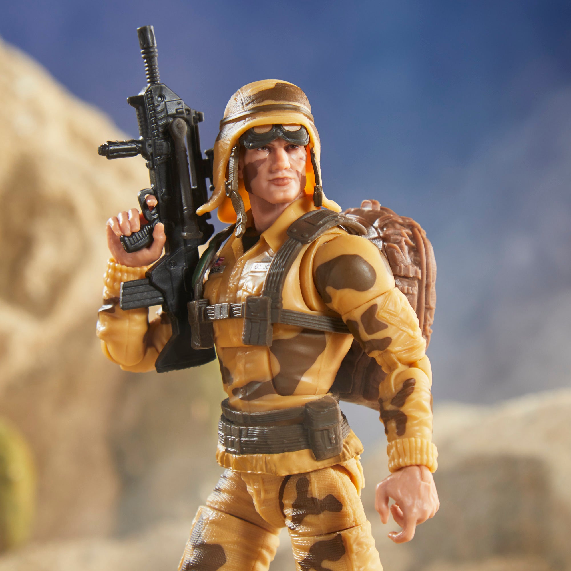 G.I. Joe Classified Series Dusty desert diorama leaping off ridge above two Cobra Vipers flanking grey-uniform G.I. Joe figure
