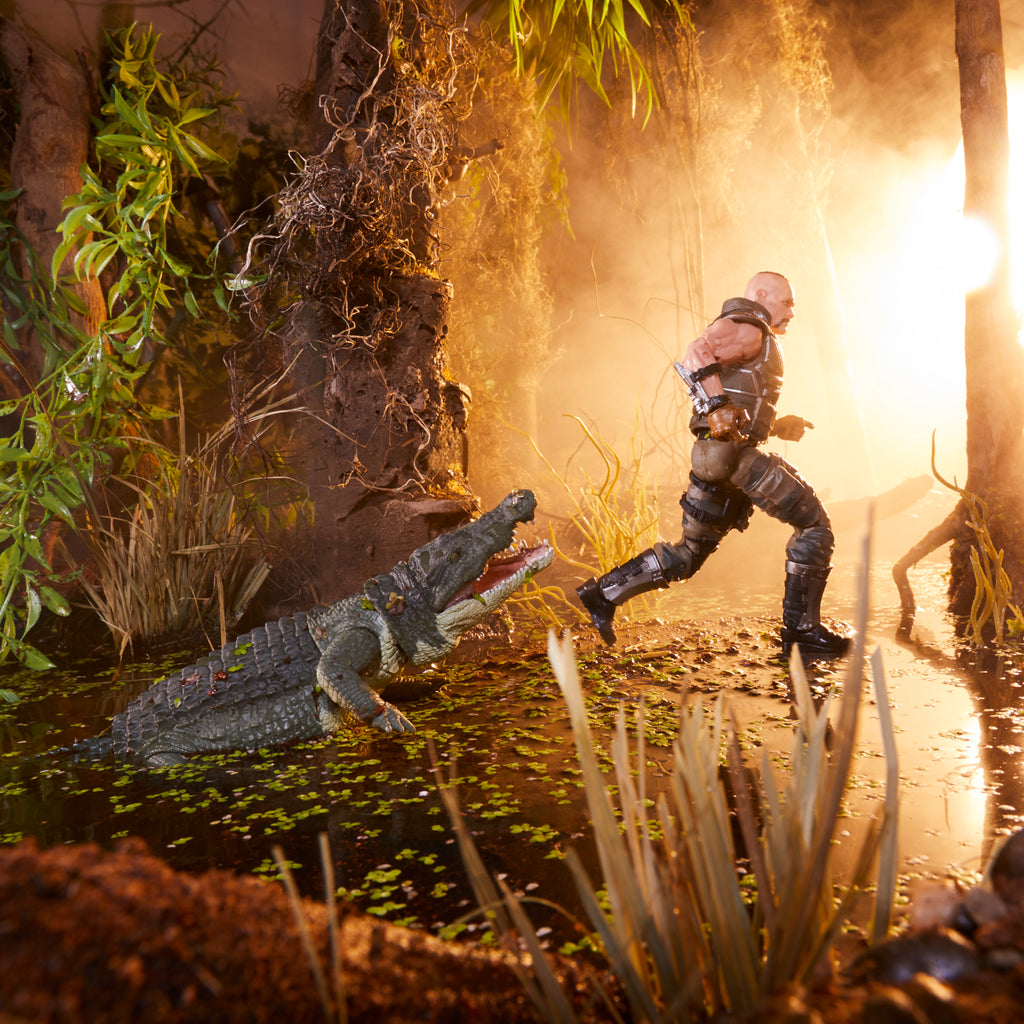 G.I. Joe Classified Series Croc Master standing in swamp diorama holding pistol with Fiona lunging open-mouthed beside him