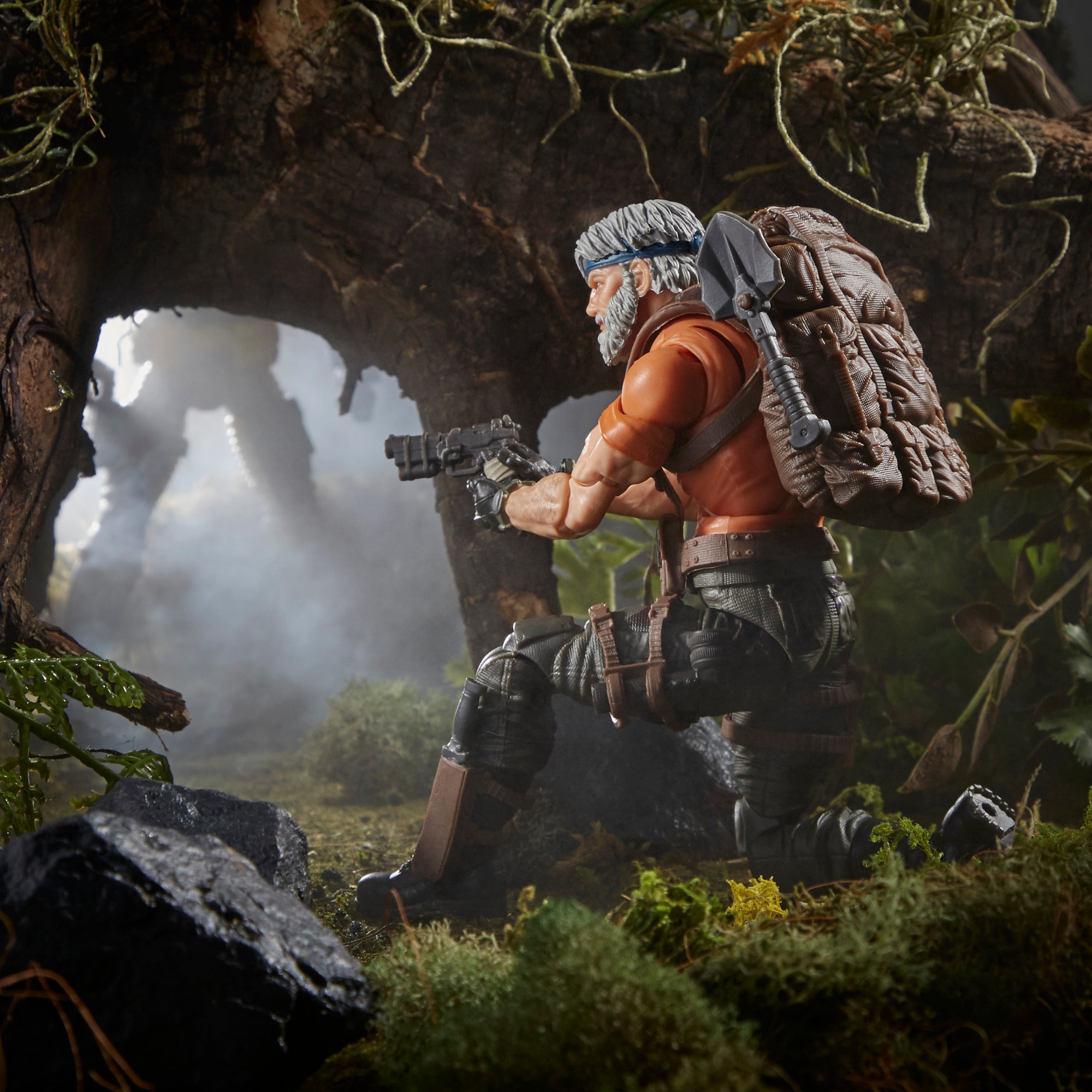 G.I. Joe Classified Series Outback Selkirk close-up aiming assault rifle through jungle foliage in rain