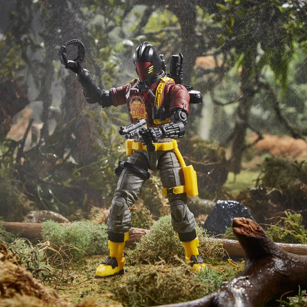 G.I. Joe Classified Series Python Patrol B.A.T. standing in jungle diorama in rain holding claw arm raised with lizard at feet