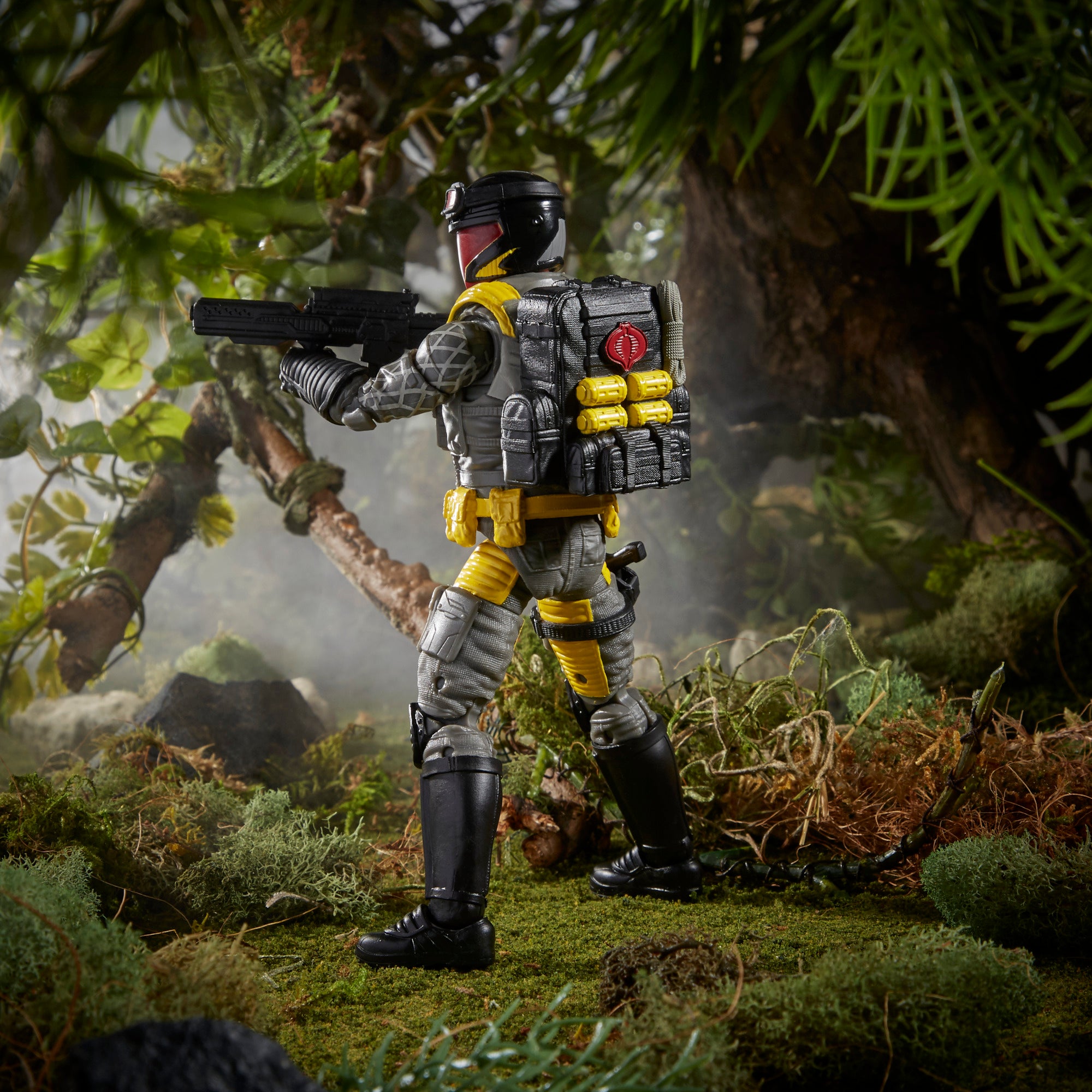 G.I. Joe Classified Series Python Patrol Cobra Viper rear view in jungle diorama showing large Cobra-logo tactical backpack with yellow canisters