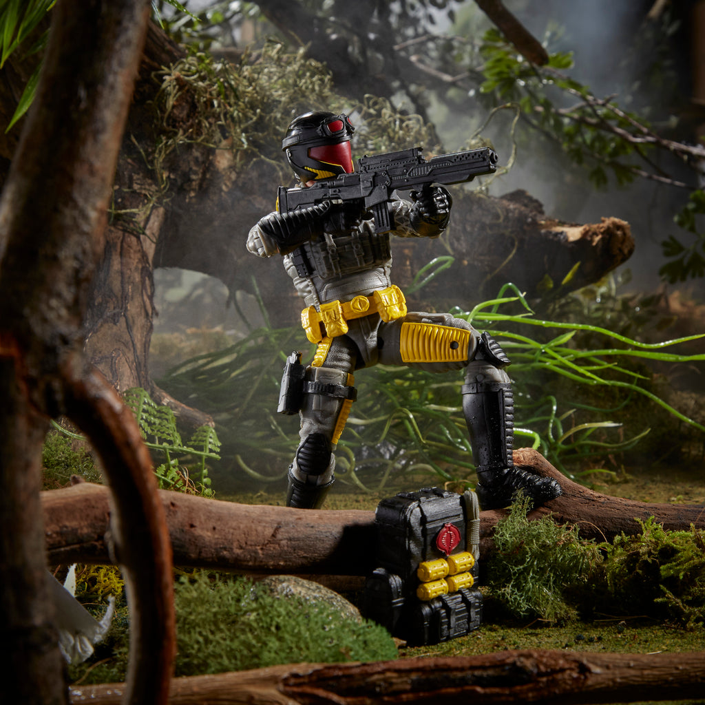 G.I. Joe Classified Series Python Patrol Cobra Viper kneeling on fallen log in jungle diorama aiming assault rifle with backpack set aside