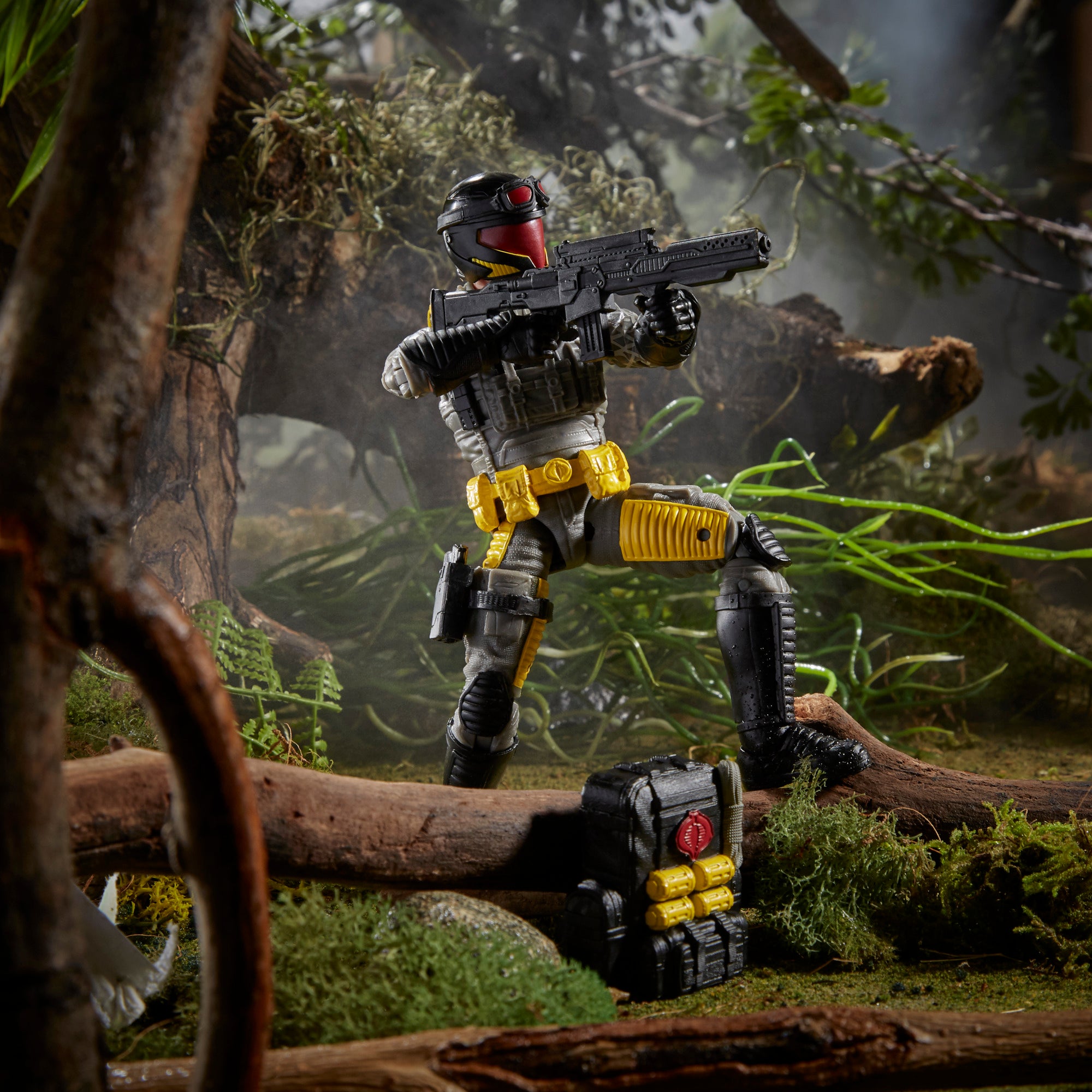 G.I. Joe Classified Series Python Patrol Cobra Viper kneeling on fallen log in jungle diorama aiming assault rifle with backpack set aside