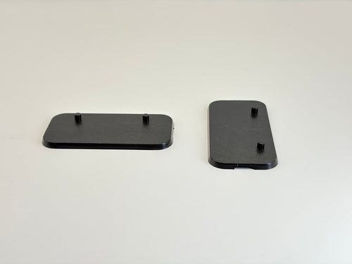 Two black rectangular plastic Action Figure Stands with two foot pegs each, shown on a plain light background.