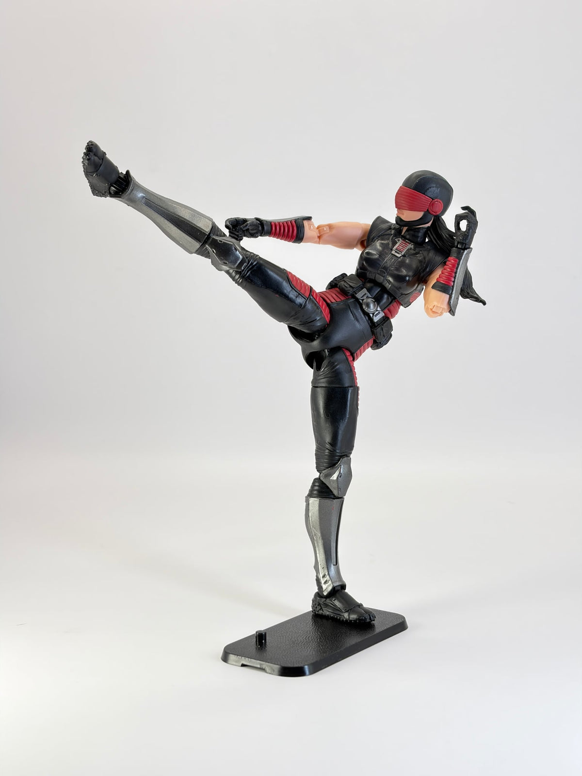 G.I. Joe Classified figure in a dynamic high kick pose, mounted on a black display stand. Figure not included.