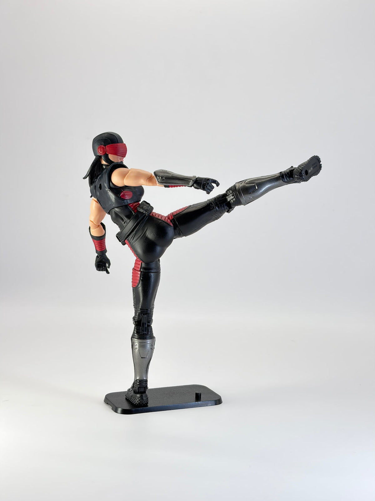 G.I. Joe Classified figure in a dynamic high kick pose, mounted on a black display stand. Figure not included.
