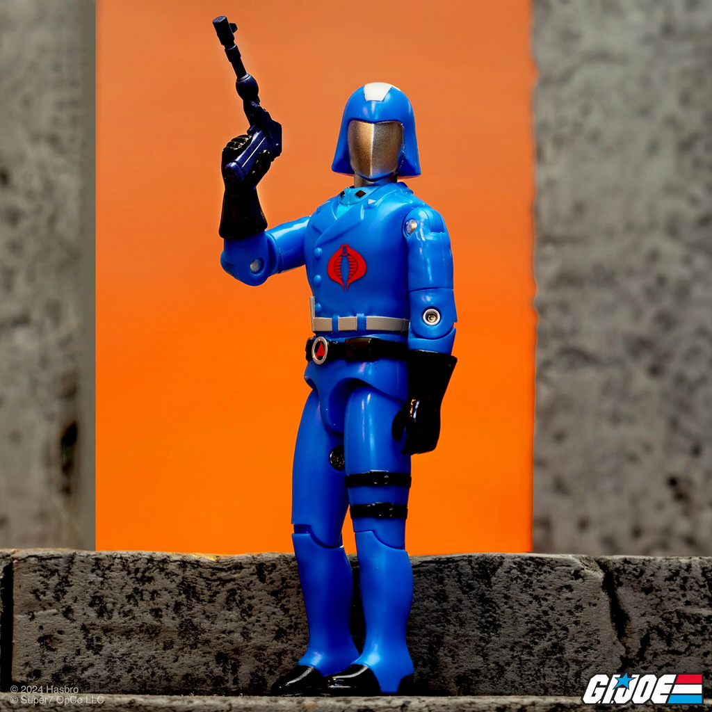 Cobra Commander Cartoon ReAction+ figure action pose with Commander Pistol raised on orange background – Super7 G.I. Joe